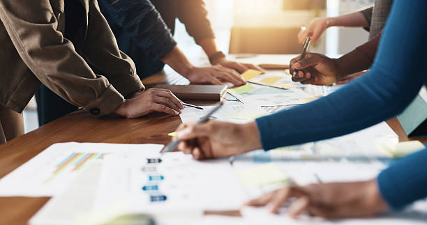 istock Documents, hands and planning with business people in office boardroom for collaboration or meeting. Infographic, marketing and strategy with employee group at work for chart, data or graph review 2229683455
