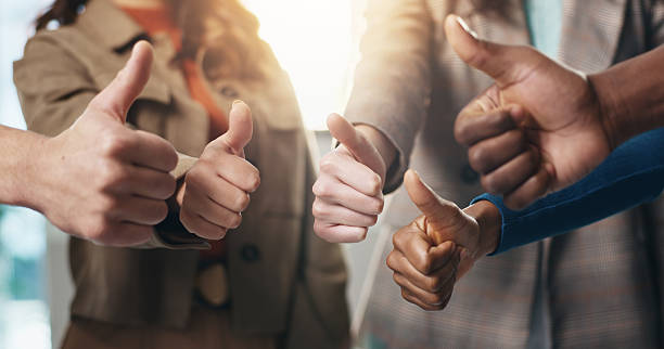 istock Business people, hands or teamwork with thumbs up for diversity, inclusion or feedback in office. Group, employees or gesture with like emoji, yes sign or OK for work cohesion, well done or agreement 2229683536