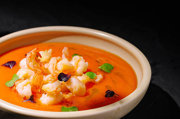 istock Creamy shrimp soup served in a rustic bowl with vibrant garnishes 2229683636