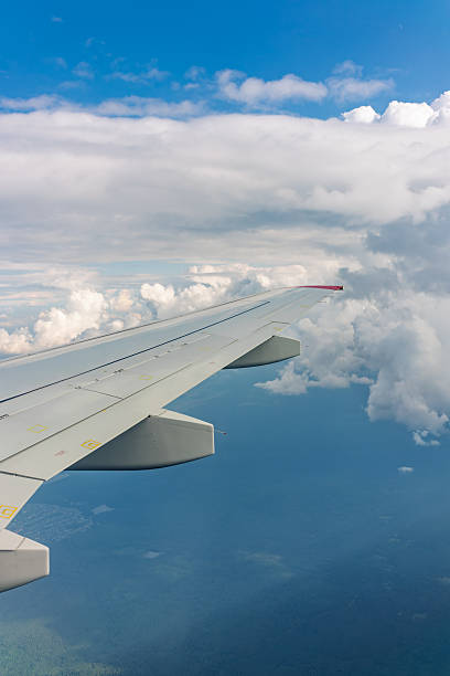 istock View from the airplane window at a beautiful cloudy sky and the airplane wing 2229687051