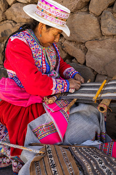 istock Peruvian woman weaving near Colca Canyon, Peru 2229687084