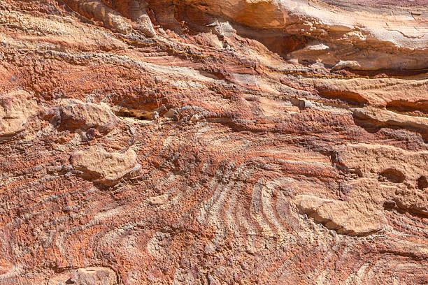 Multi-colored sandstone rock and mineral layers in ancient tombs of Petra, Jordan. Pattern, geological stone texture
