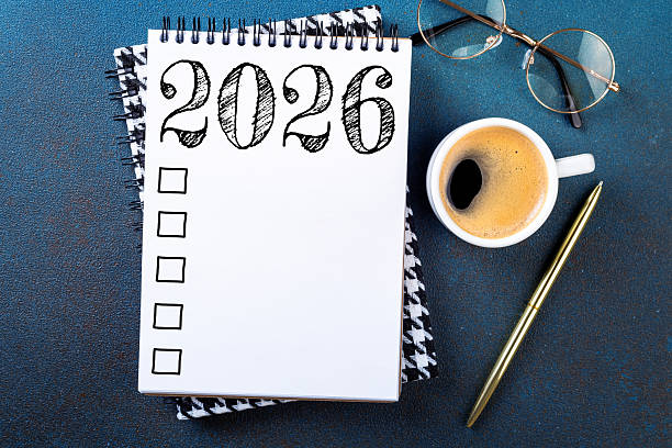 istock New year resolutions 2026 on desk. 2026 resolutions list with notebook, coffee cup on table. Goals, resolutions, plan, action, checklist concept. New Year 2026 template 2229689889