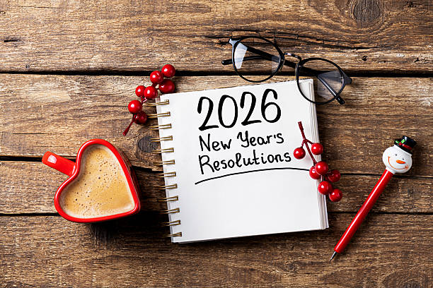 istock New year resolutions 2026 on desk. 2026 goals list with notebook, coffee cup on wooden table. Resolutions, plan, goals, action, checklist, idea concept. New Year 2026 resolutions 2229689998