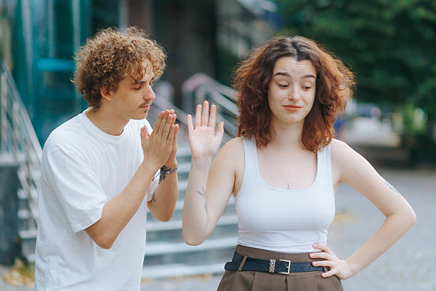 istock Heartbroken man tries to stop girlfriend from walking away 2229690126