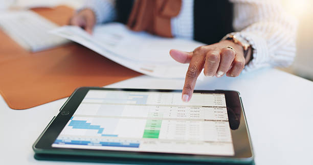 istock Hands, tablet and screen with spreadsheet, office and human resources management at corporate agency. Person, touchscreen UX and click for statistics review, chart and paperwork for admin at company 2229696647