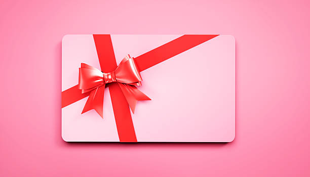 istock Pink credit or gift card with red ribbon 2229698754