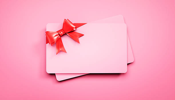 istock Pink credit or gift card with red ribbon 2229698760