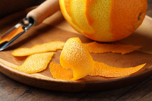 istock Fresh orange peel and fruit on wooden table, closeup 2229705827
