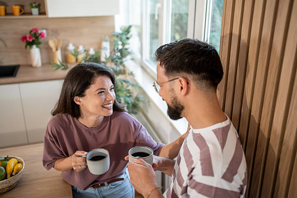 istock Happy couple enjoying morning coffee together in kitchen 2229708642