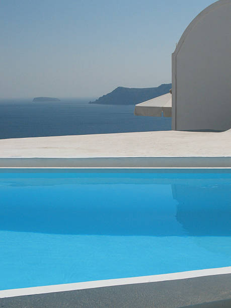 Infinity pool with crystal blue water view to sea  ocean.