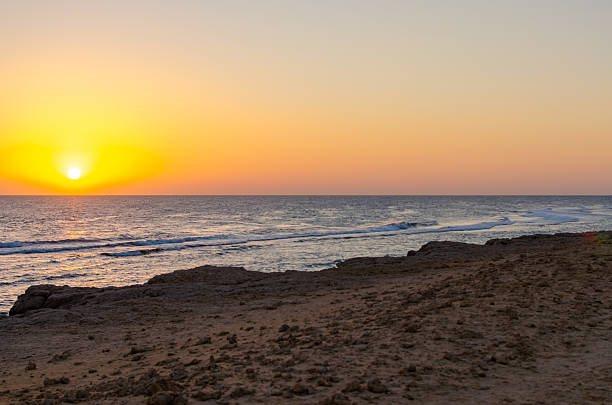 Golden sunset with calm waves and sandy coastline in Egypt 2 March 2025.