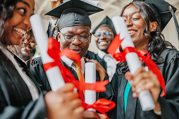 istock Joyful graduation celebration among diverse university students with diplomas in hand at campus after achieving academic success 2229717240