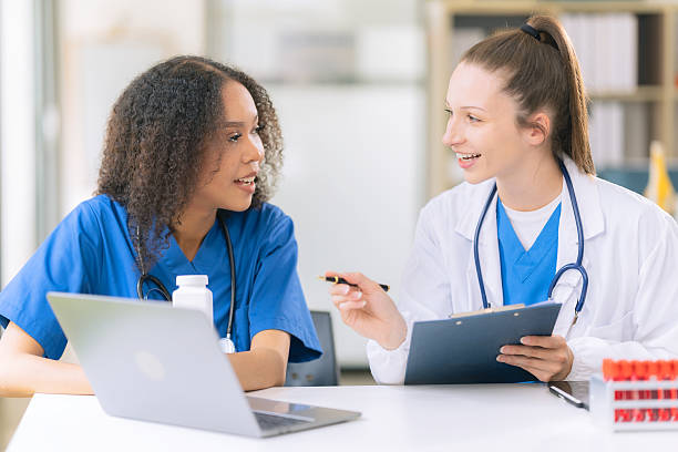 istock Science concept. Two female doctors are conducting research, studying substances under a microscope in a modern medical laboratory. 2229720063