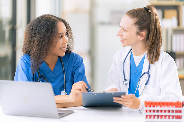 istock Science concept. Two female doctors are conducting research, studying substances under a microscope in a modern medical laboratory. 2229720071