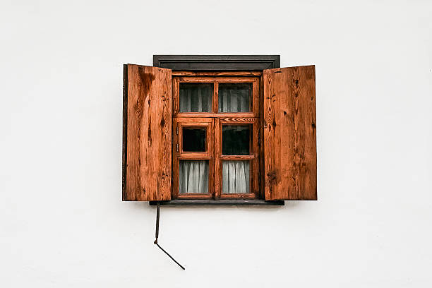 istock Rustic wooden window with open shutters on white wall 2229721894