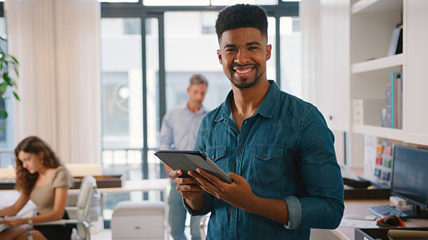 istock Young Smiling Businessman With Digital Tablet Standing And Working In Modern Office 2229724950