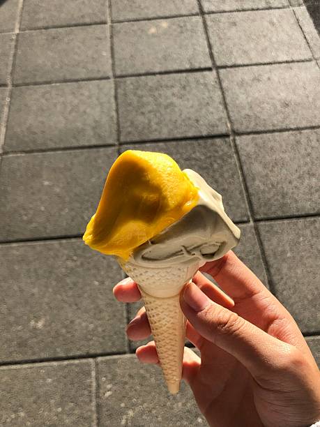 istock Creamy ice cream scooped into a crunchy waffle cone, melting slightly under warm sunlight. The perfect treat with classic flavors and a nostalgic touch. 2229725177