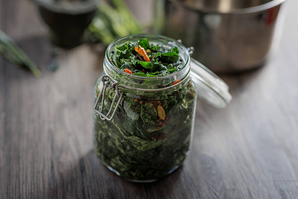 A close-up of preparing pickled cavolo nero kale in a home kitchen.