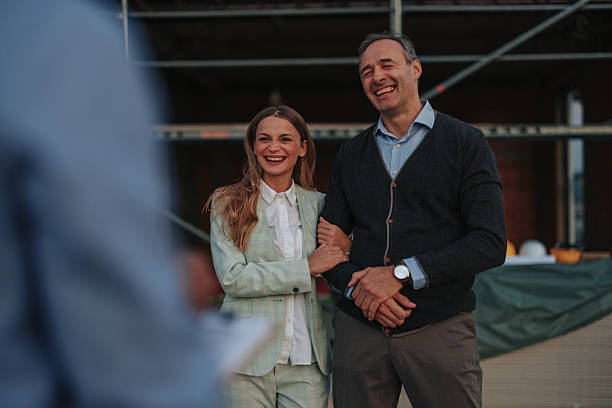 istock Happy Couple Smiling at Architect During Construction Site Visit 2229728507