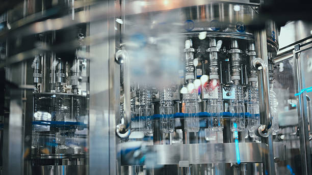 istock labeling and sealing packaging machine in PET plastic packaging drinking or beverage product packaging line automated labeling of round containers in smart production facility 2229728523