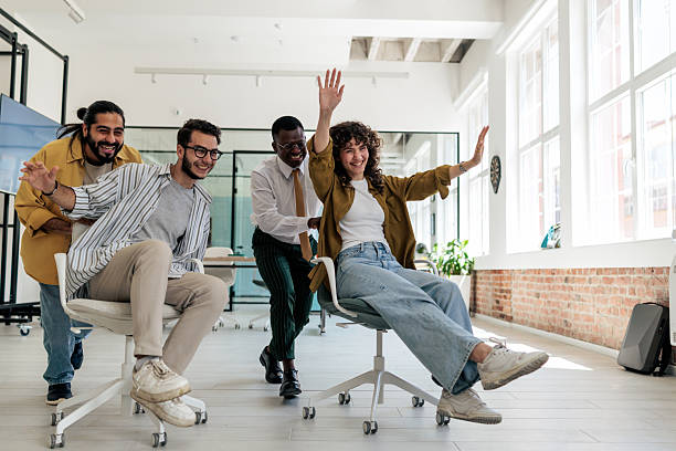 istock Coworkers Having Fun with Office Chairs 2229728750
