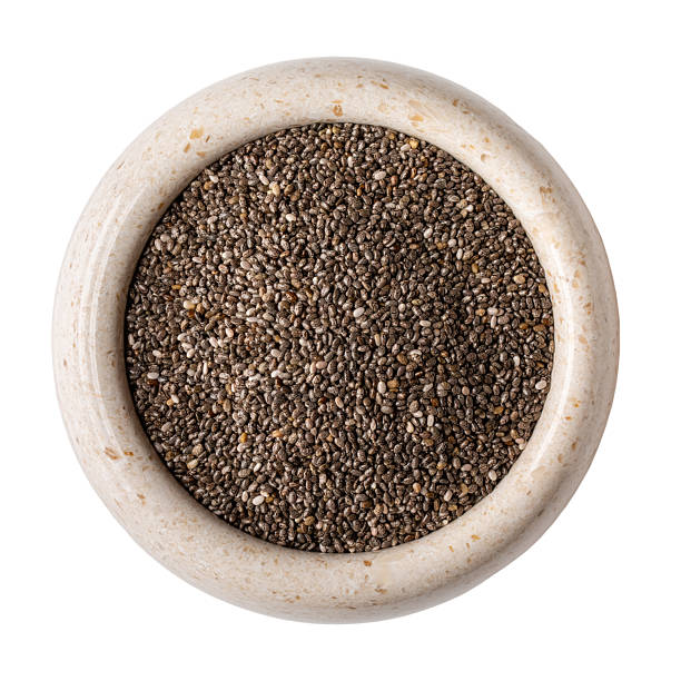 istock Chia seeds in stone bowl isolated on white background. Top view. 2229730281
