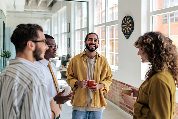 istock Group of Coworkers Enjoying Coffee Break at Work 2229730892