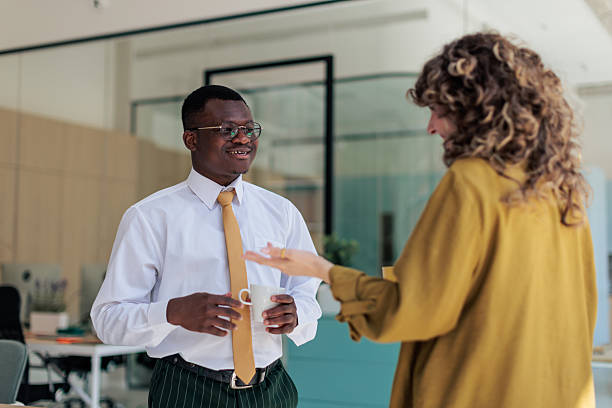 istock Coworkers Chatting and Enjoying Coffee Break at Work 2229731259