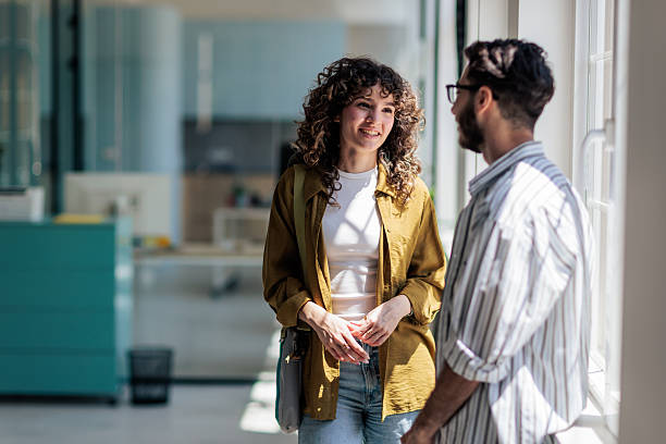 istock Coworkers Laughing and Talking During Coffee Break 2229731607