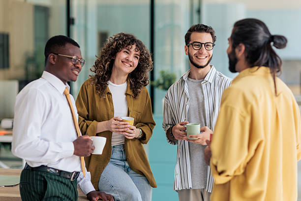 istock Coworkers Laughing and Talking During Coffee Break 2229731634