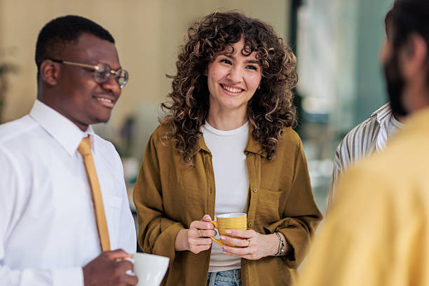istock Coworkers Laughing and Talking During Coffee Break 2229731689
