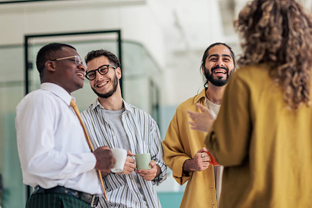 istock Coworkers Laughing and Talking During Coffee Break 2229731717