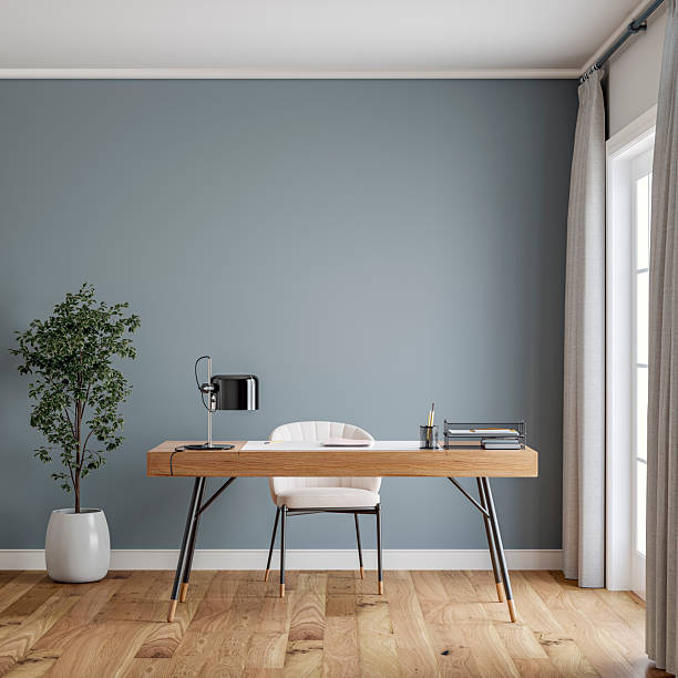 istock Stylish minimalist (scandinavian) home office interior with a desk in front of a medium gray wall background, french window and decoration 2229732041