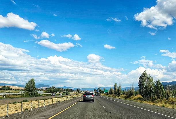 Driving road trip on the highway on a clear day, the sky and clouds are beautiful.