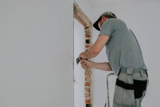 istock A young Caucasian male builder clears a doorway using a crowbar. 2229732650