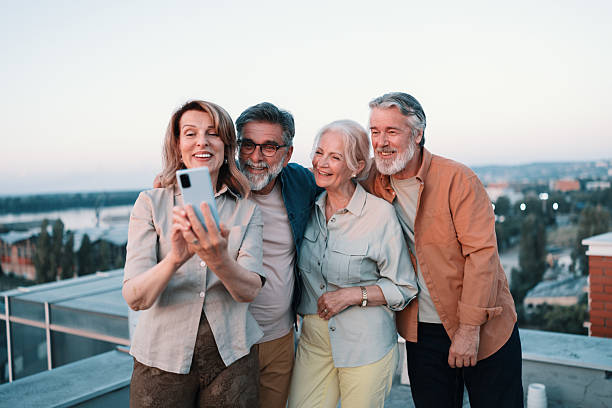istock Seniors laughing together during rooftop sunset gathering 2229735493