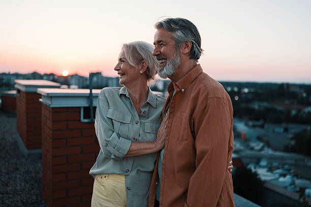 istock Senior couple enjoying retirement on rooftop at sunset 2229735678