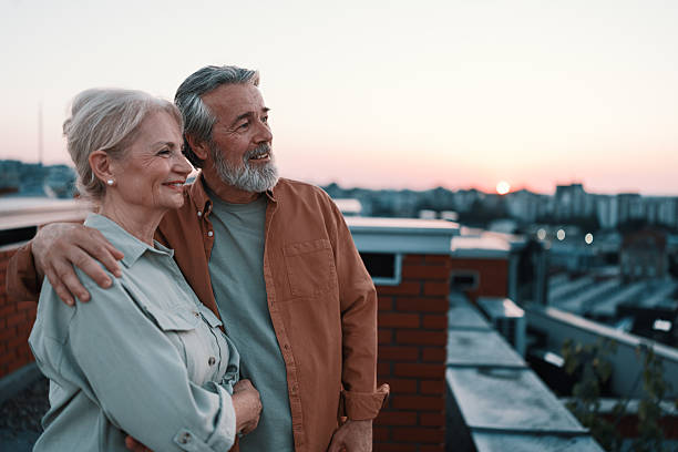 istock Senior couple enjoying sunset on rooftop 2229735813