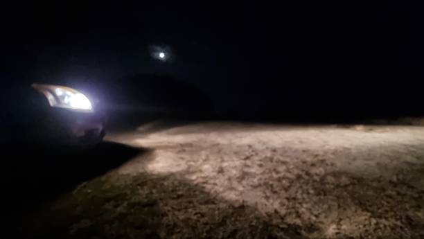 istock car lights in dark night hour 2229736997