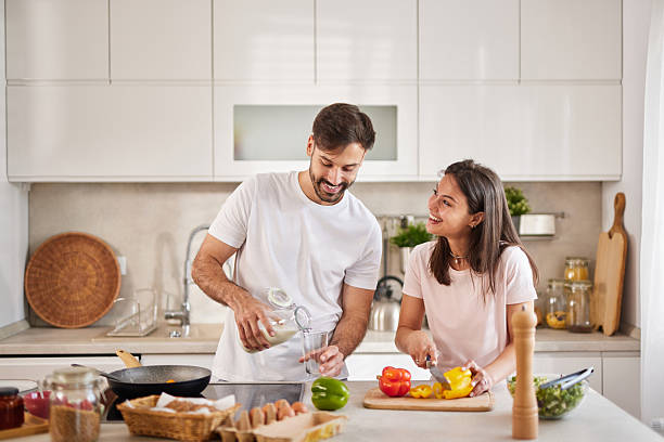 istock Happy couple preparing breakfast together in modern kitchen 2229737017
