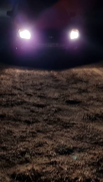 istock car lights in dark night hour 2229737401