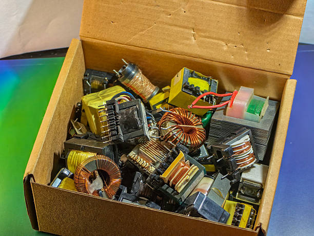 istock Assorted electronic transformers fill a cardboard box, creating a detailed close-up view. 2229737553