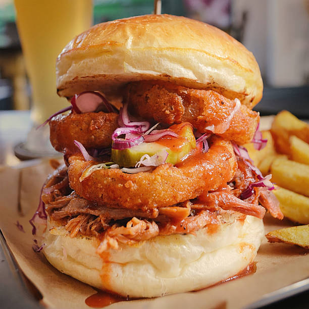 istock Pulled Pork Burger served with thickly cut beefsteak fries, traditionally on parchment. 2229737589