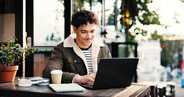 istock Creative, remote work and man with laptop, cafe and email marketing on website, research and online. Freelance, copywriter and person with tech for article, coffee shop and typing project on app 2229738982