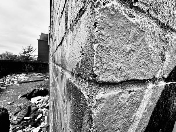 istock The corner angle of a brick wall sprayed with graffiti with abandoned rubbish on the ground at Newcastle Upon Tyne 2229739842