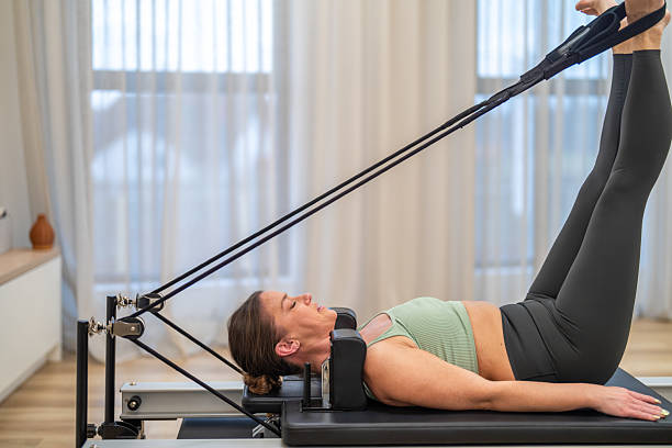 istock Caucasian Woman Exercising on Pilates Reformer Machine 2229742193