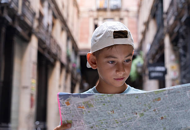 Young tourist navigating the streets of Barcelona, intently reading a map while discovering the historic charm of the Gothic Quarter