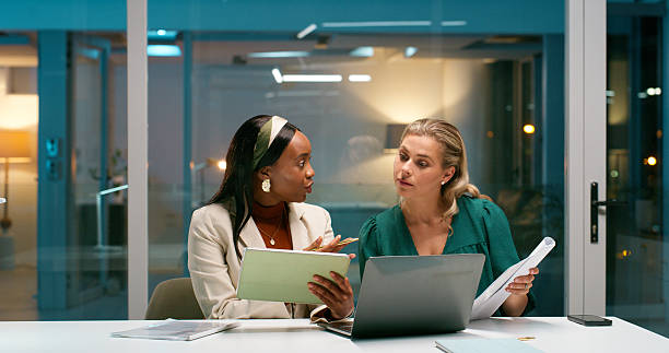 istock Creative, teamwork and women with laptop, office or collaboration for article, journalist and night. Online, reporter and people with tech, talking and planning for story, working late or deadline 2229742651