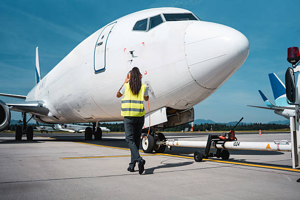 istock Airport Ground Crew Woman Inspecting Cargo Jet During Systems Test 2229742715